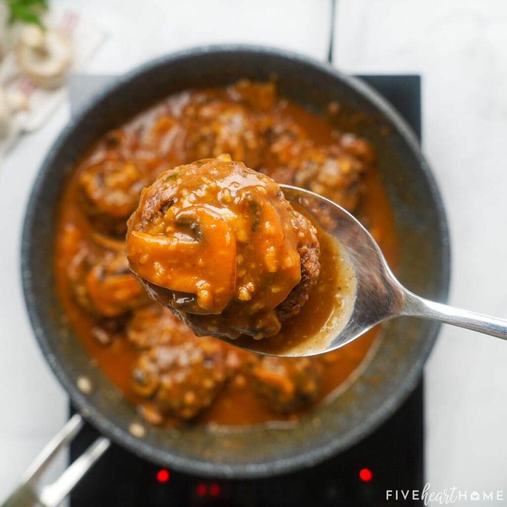 Spoonful of Hamburger Steak with Mushroom Gravy.