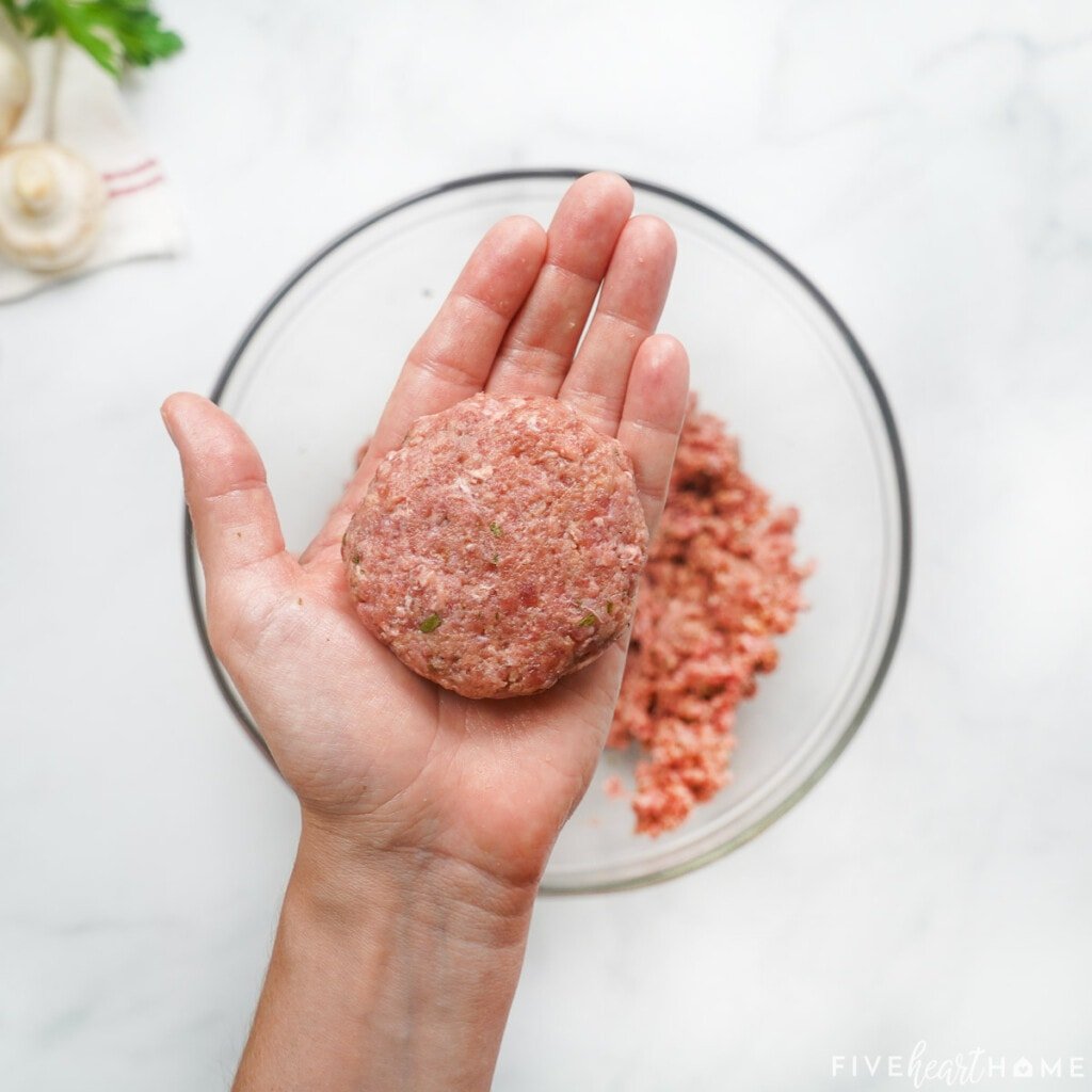 Pressing ground beef into a patty for hamburger steak recipe.