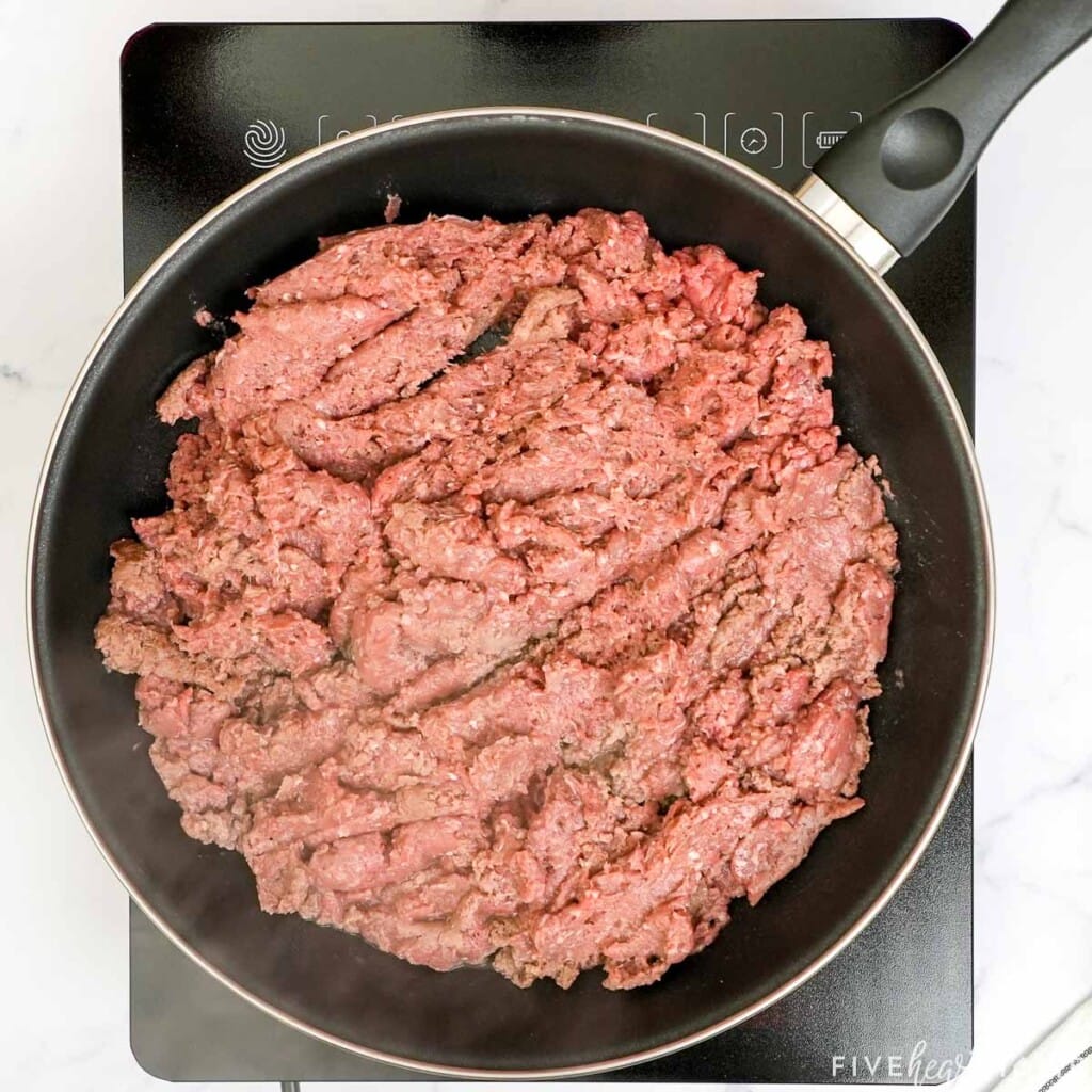 Browning ground beef in skillet.