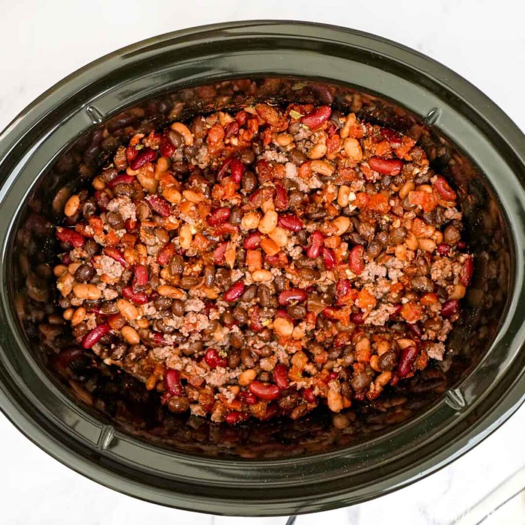 Ingredients combined in slow cooker for 3 Bean Chili recipe.