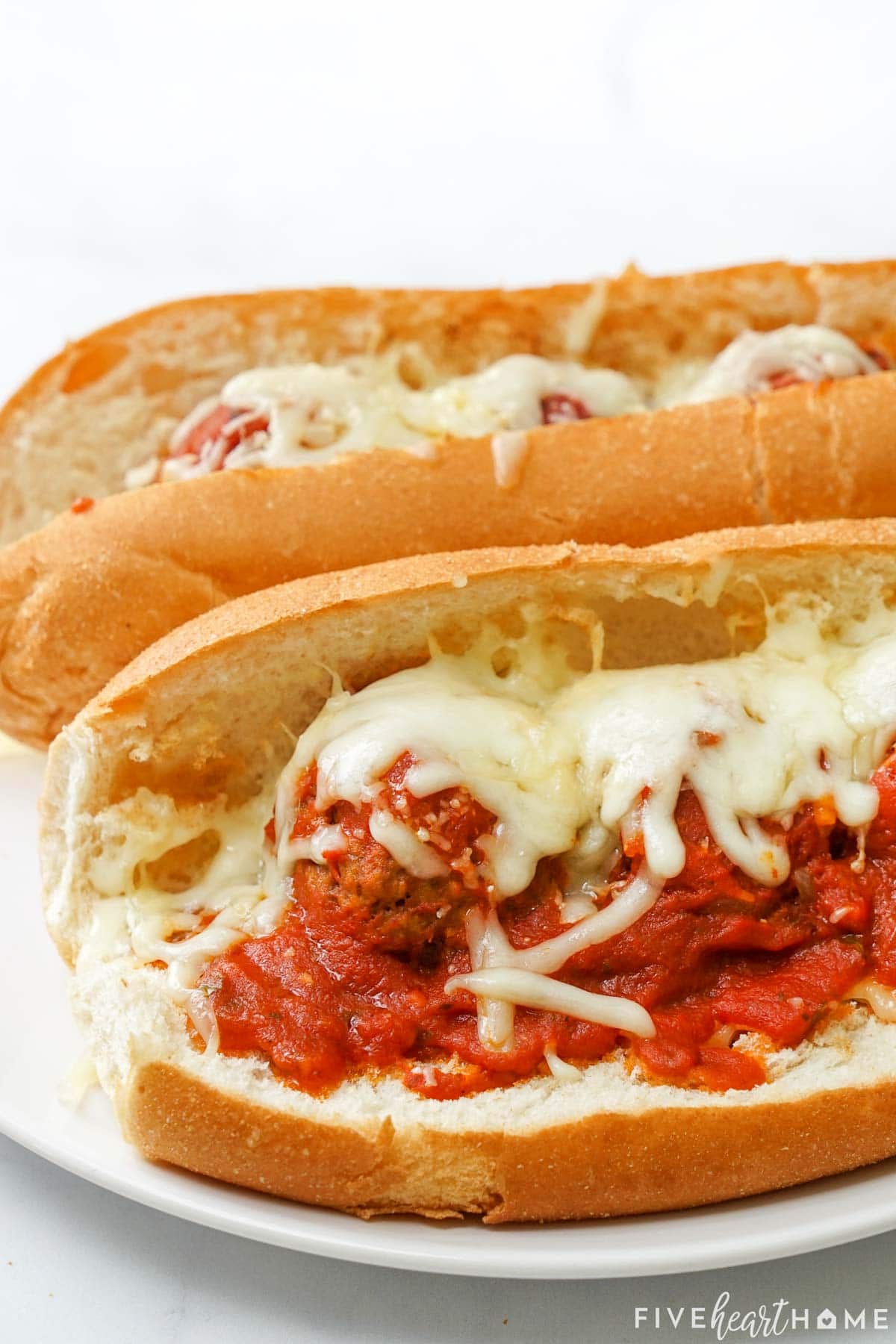 Meatball subs in crockpot on hoagie rolls.