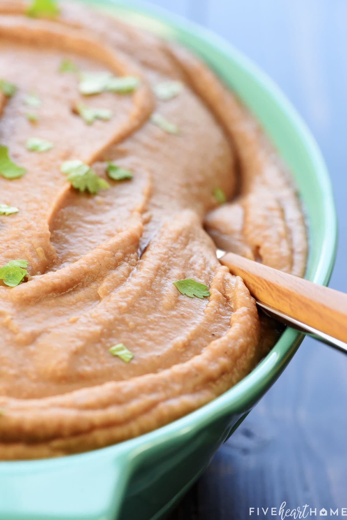 Close-up of refried beans recipe with spoon.