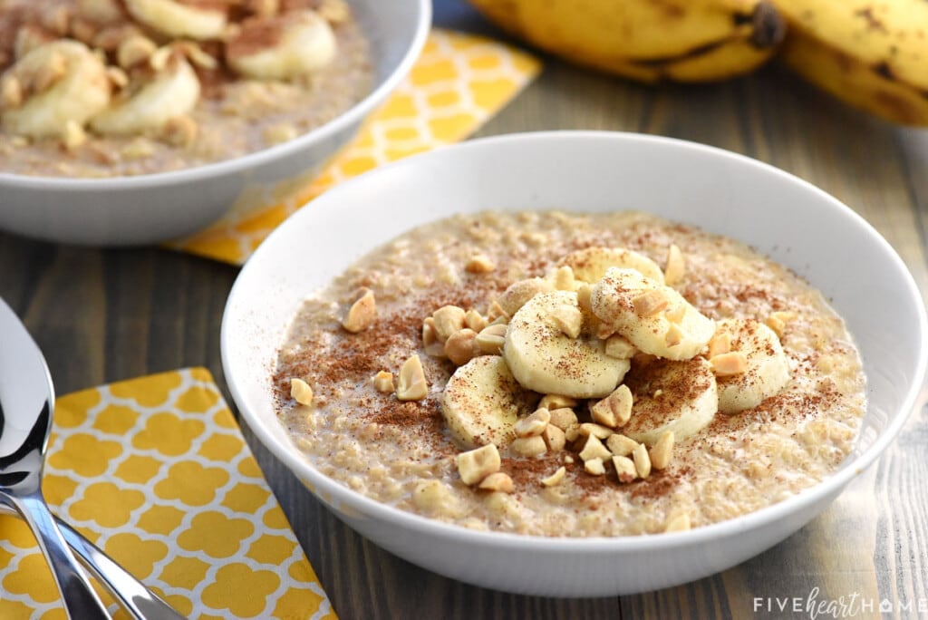 Banana Oatmeal in two bowls with peanut butter and cinnamon stirred in.