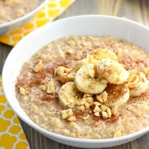 Peanut Butter Banana Oatmeal in a bowl garnished with toppings.
