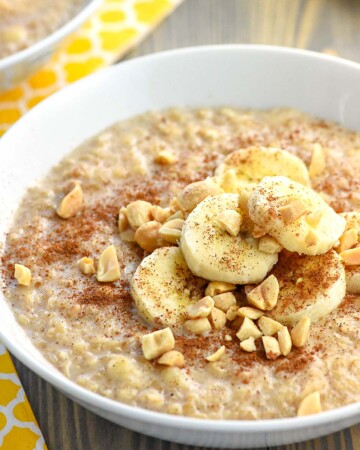 Peanut Butter Banana Oatmeal in a bowl garnished with toppings.