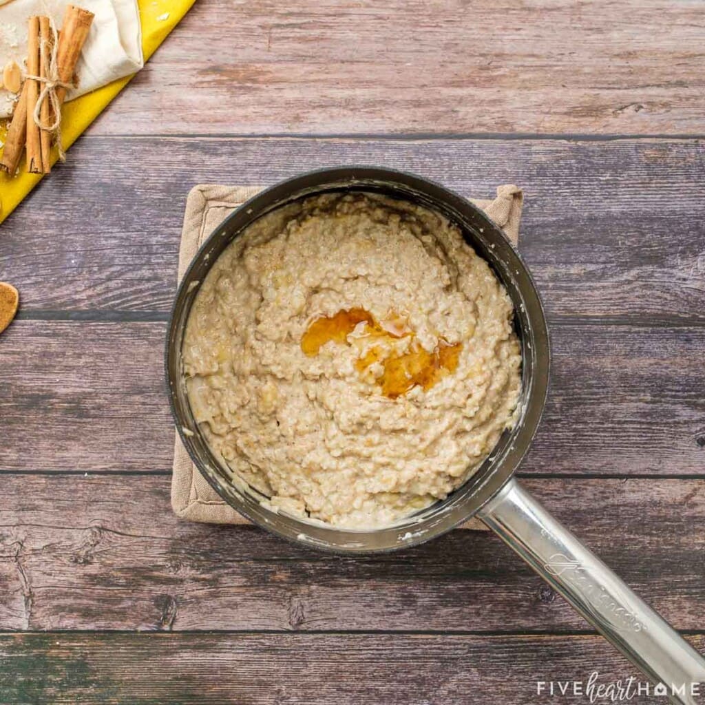 Oatmeal and peanut butter in pot with honey on top.