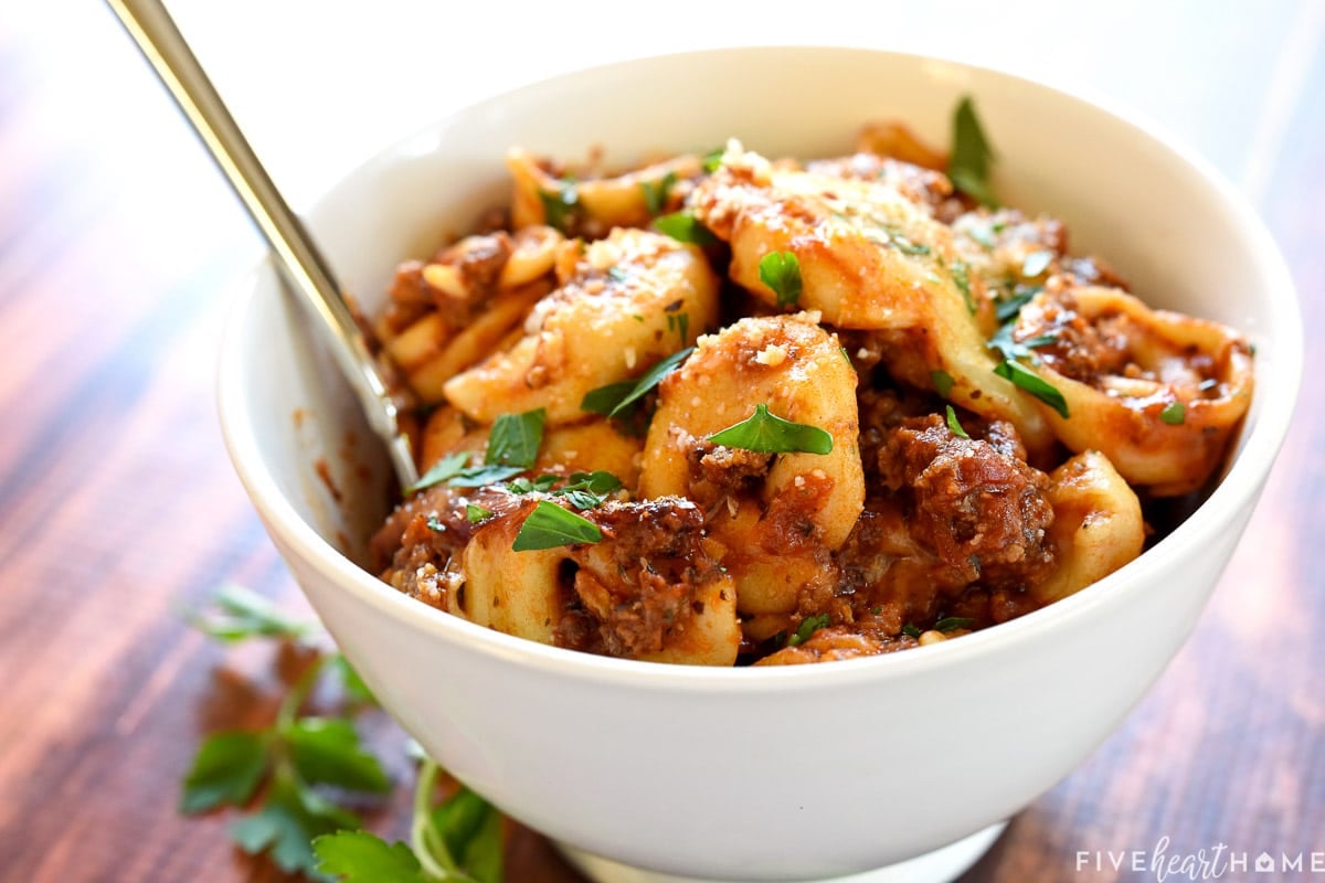 Bowl of Baked Tortellini garnished with parsley.