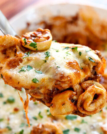 Beef Tortellini with ground beef and cheese on serving spoon.