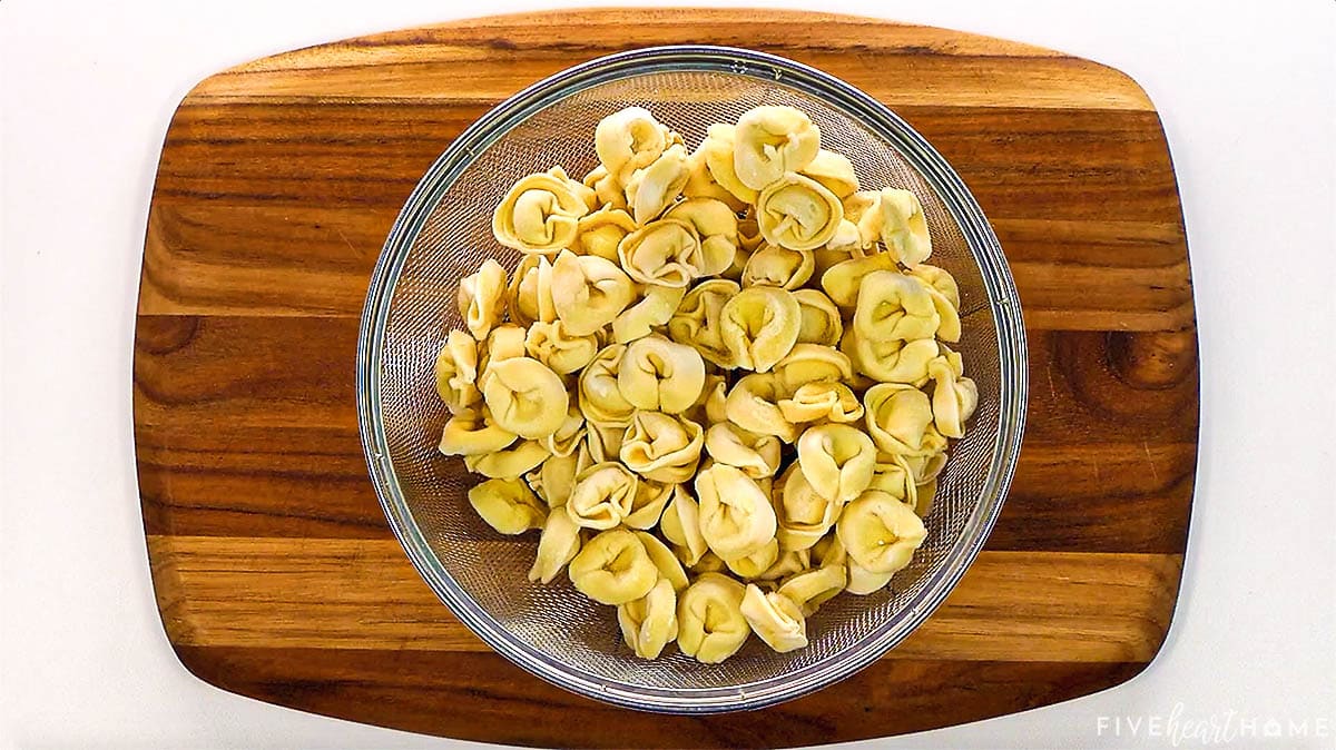 Cheese tortellini drained in colander.