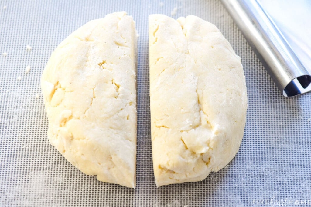 Cutting disk in half for pie crust recipe with butter.