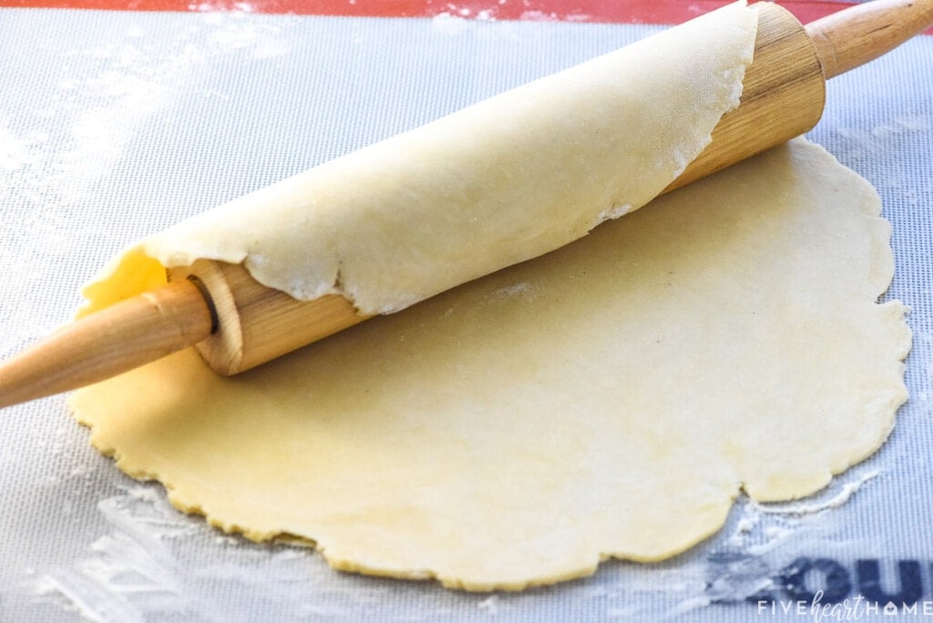 Homemade pie crust over rolling pin.