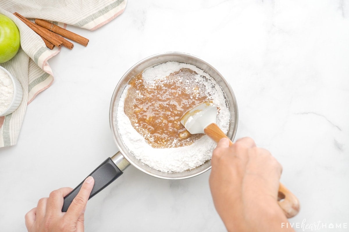 Stirring powdered sugar into caramel glaze.