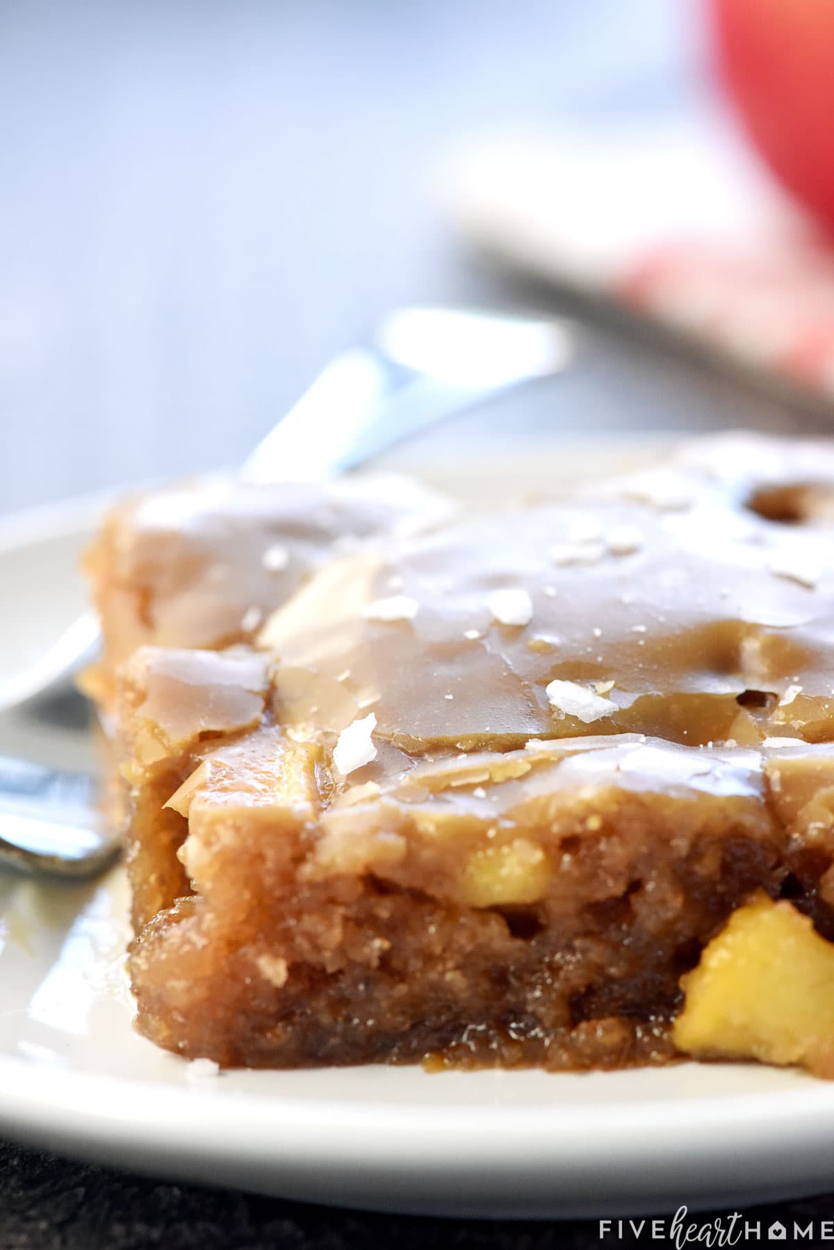 Close-up of Caramel Apple Cake with chunks of apple and caramel glaze.