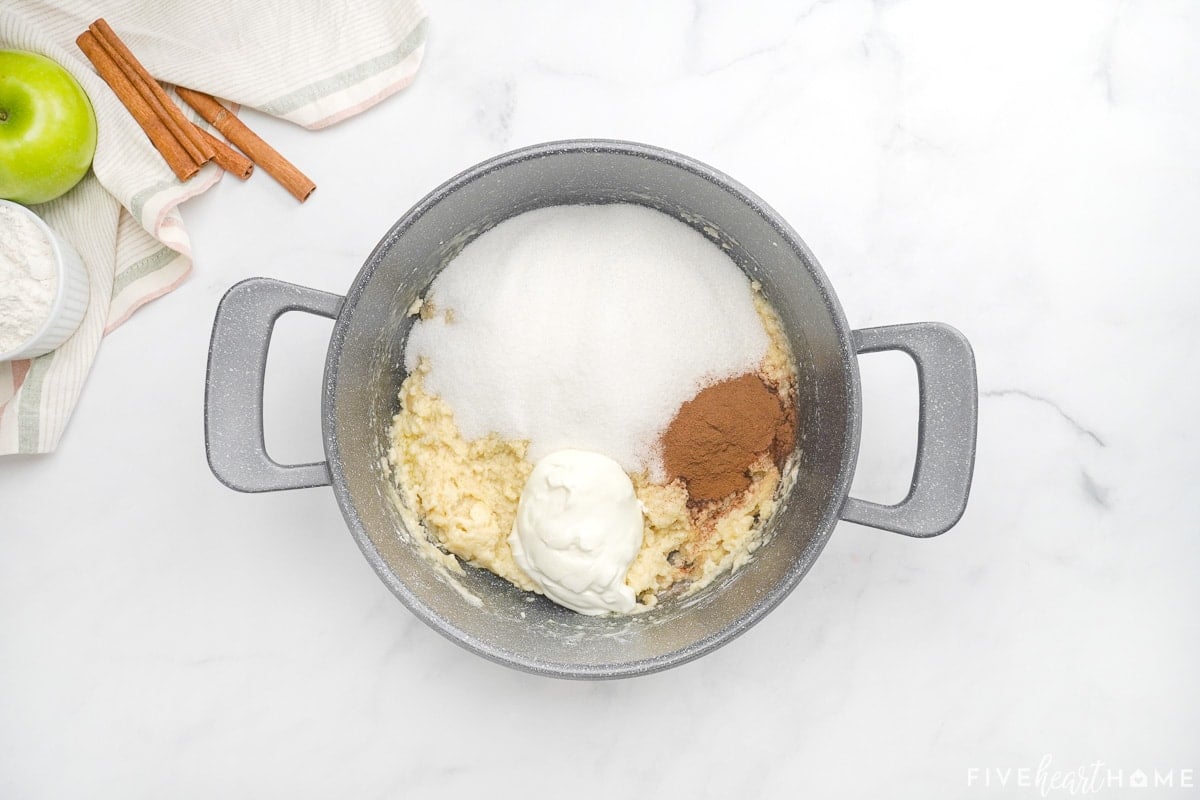 Stirring in additional ingredients to make apple cake with caramel glaze.