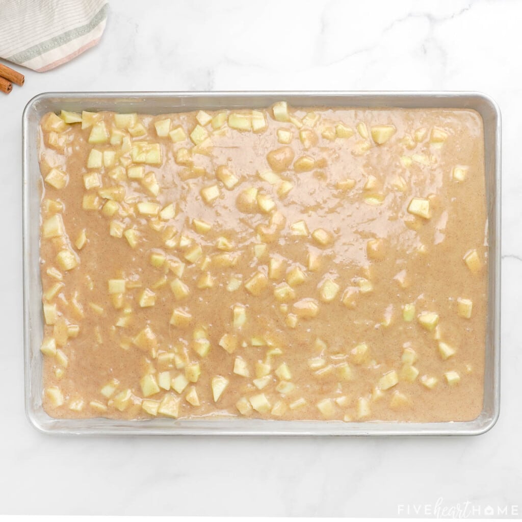 Pouring batter into pan for apple sheet cake.