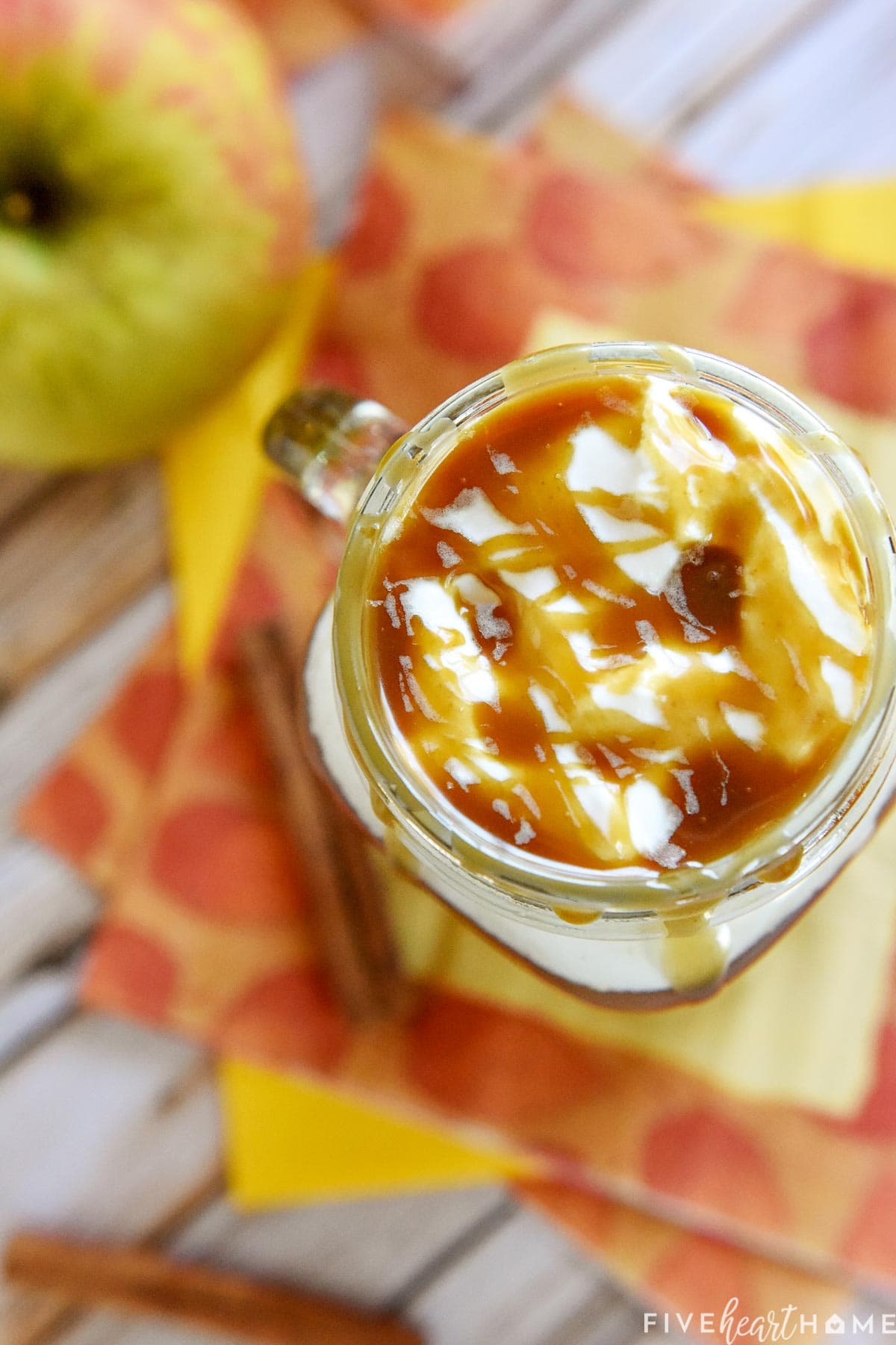 Aerial view of mug topped with whipped cream and caramel sauce.