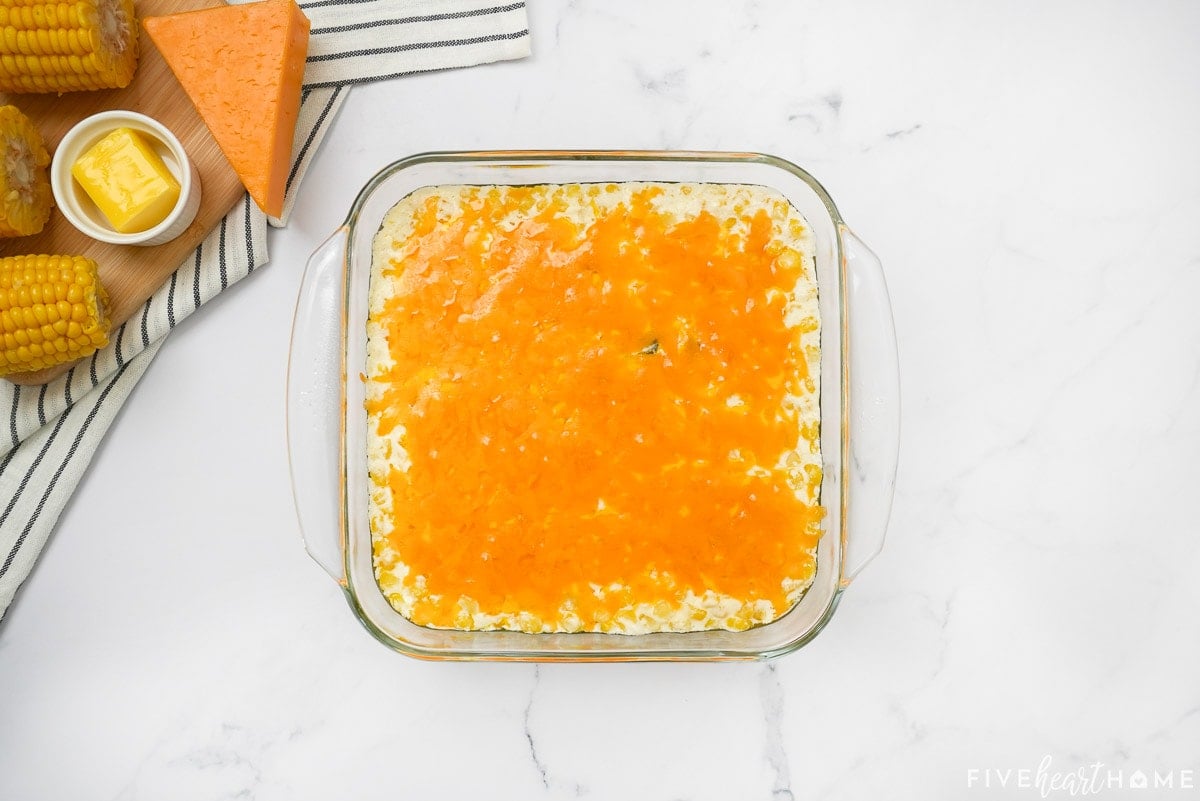 Cheesy corn casserole baked in dish.