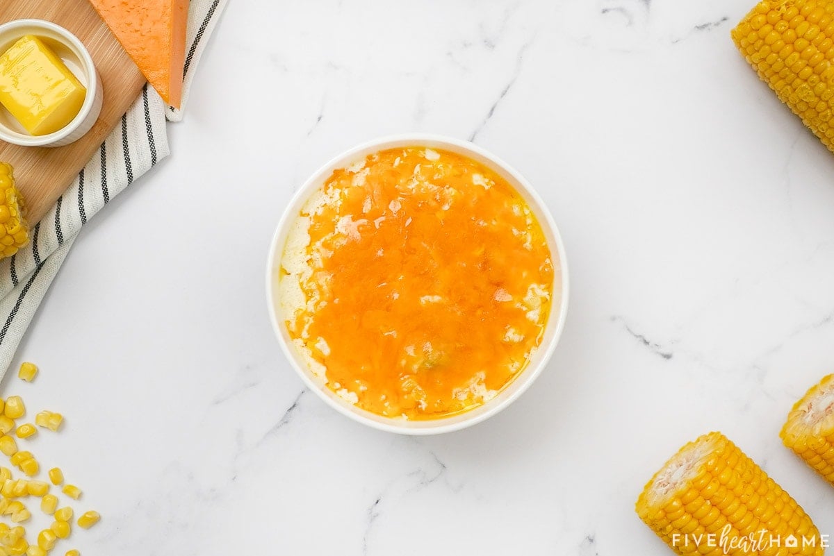 Corn casserole with cream cheese in serving bowl.