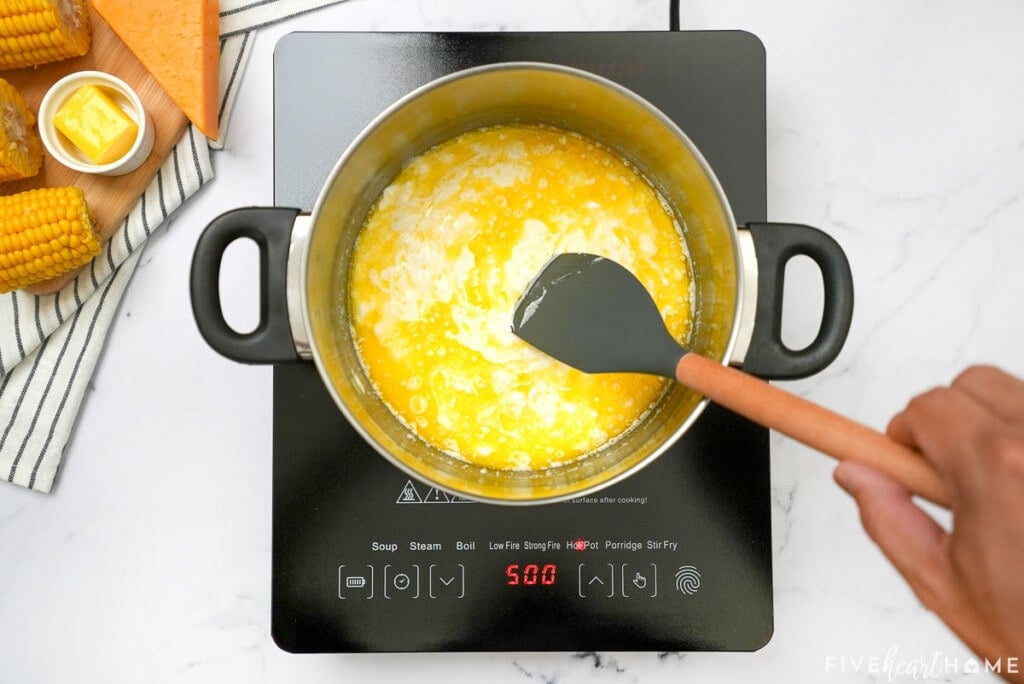 Stirring ingredients in pot for Cream Cheese Corn Casserole.