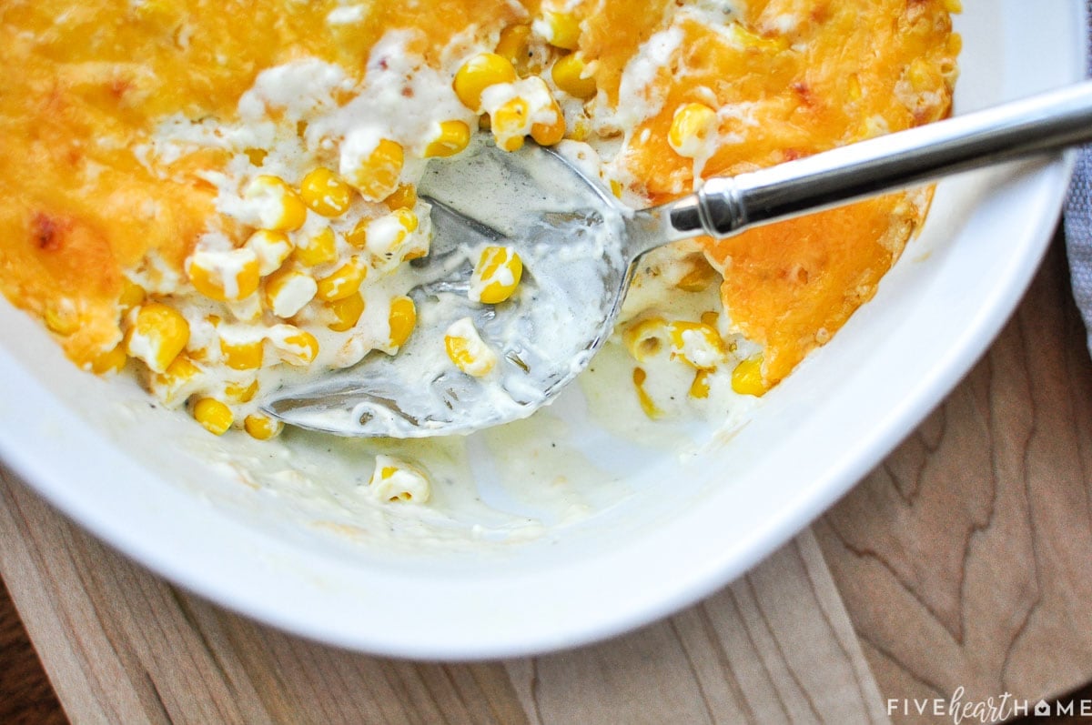 Cream Cheese Corn Casserole in dish with spoon.