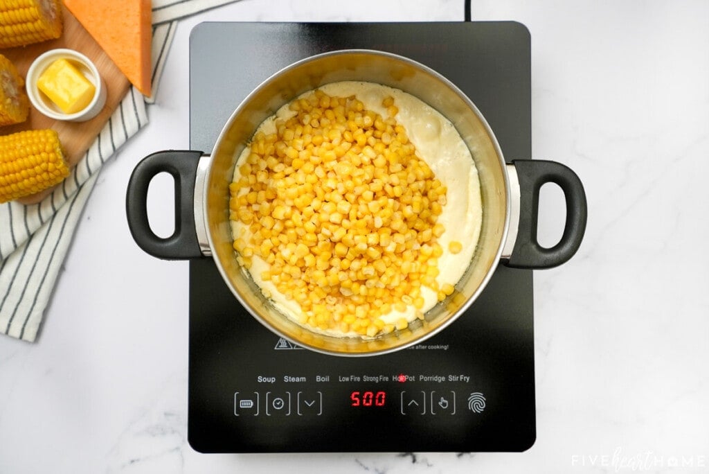 Adding corn to mixture for corn casserole recipe.