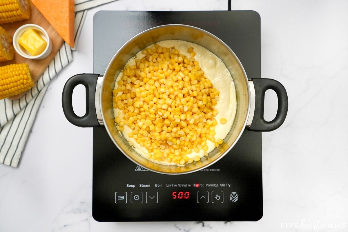 Adding corn to mixture for corn casserole recipe.