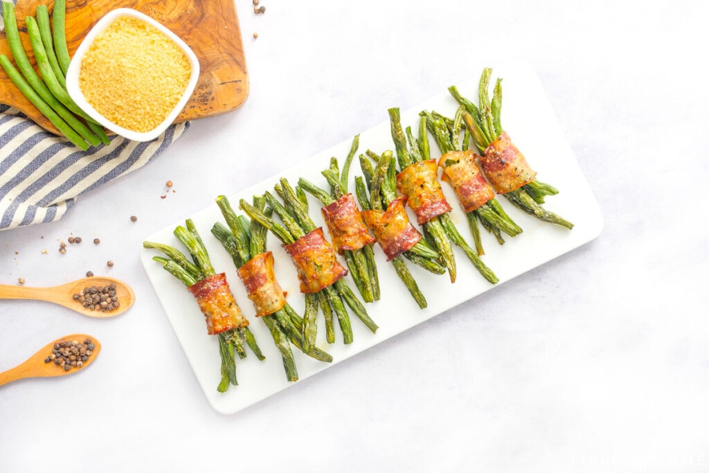 Aerial view of Green Bean Bundles on rectangular white platter.