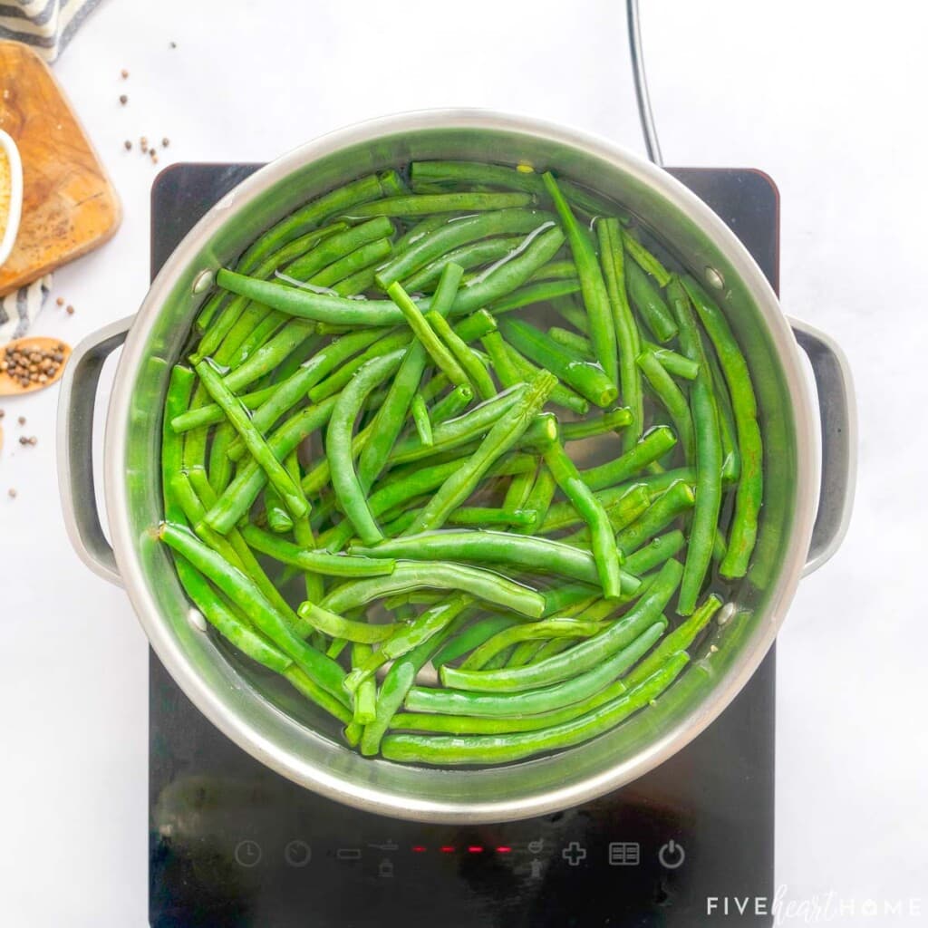 Green beans in pot of boiling water.