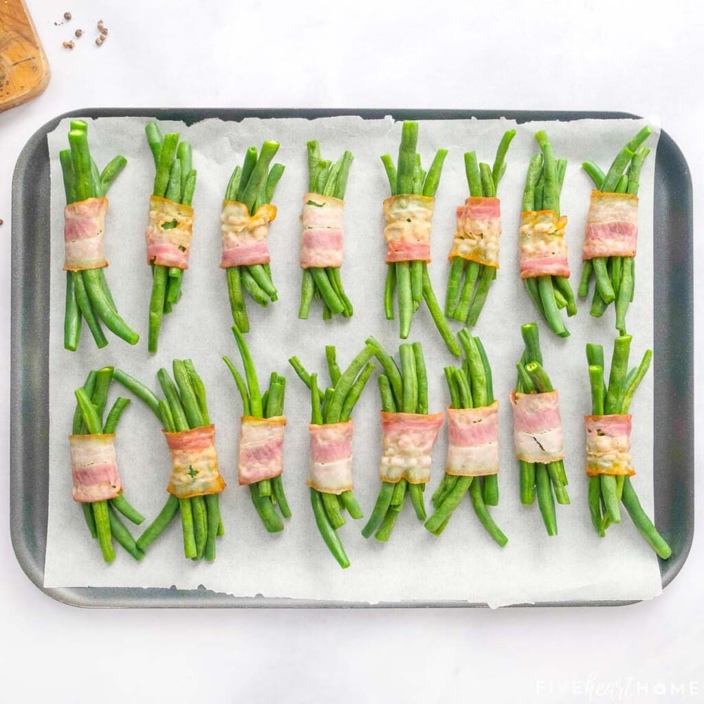 Green Bean Bundles with bacon on baking sheet.