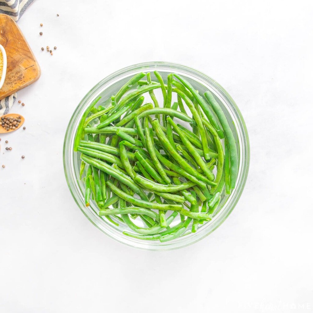 Blanching green beans in ice water.