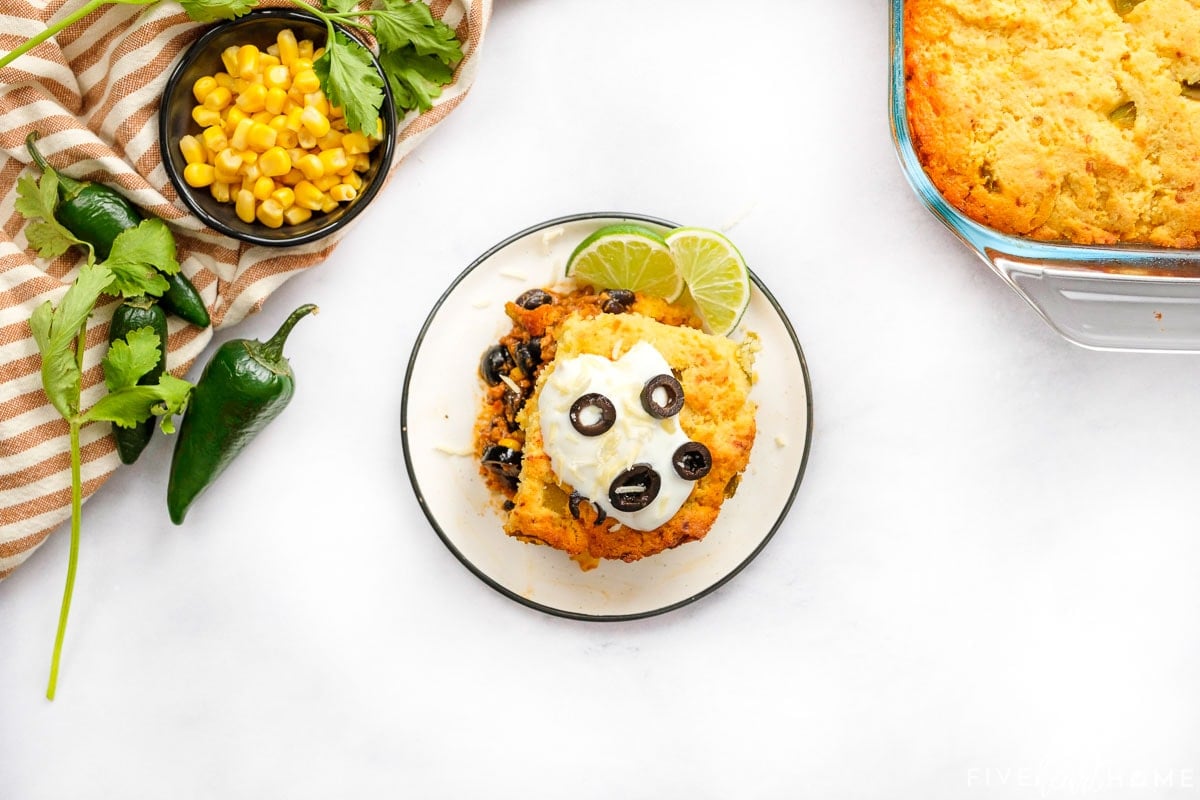 Aerial view of taco casserole with cornbread and black beans.