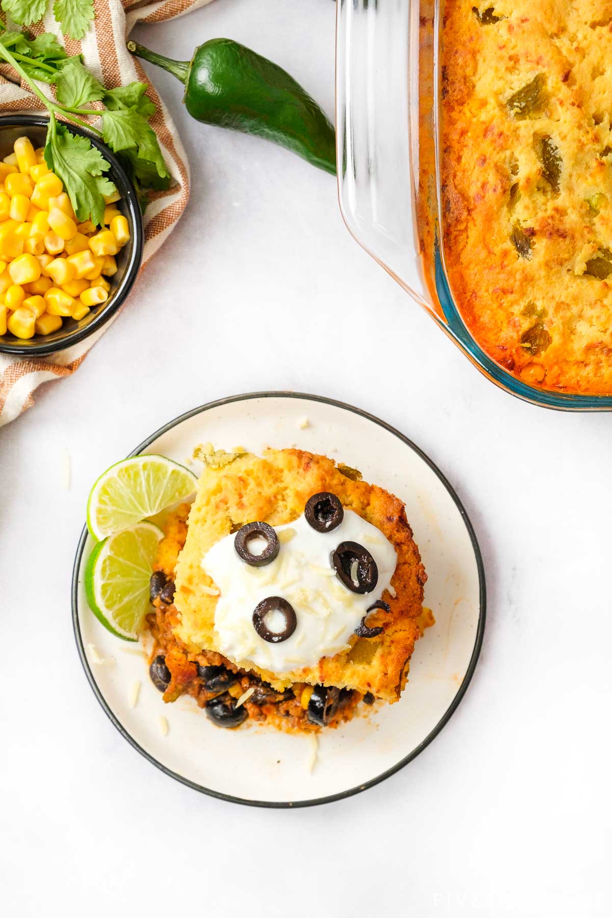 Aerial view of Mexican Cornbread Casserole on plate and in dish.