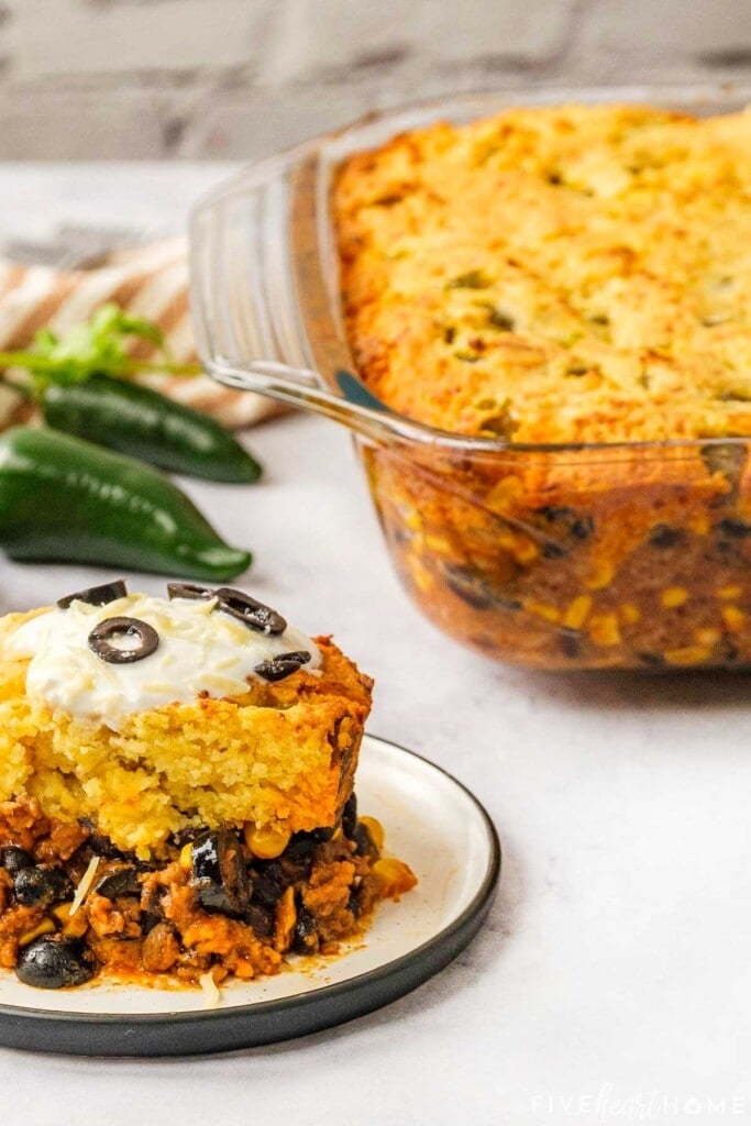 Mexican Cornbread Casserole with beans and corn, on plate and in baking dish.