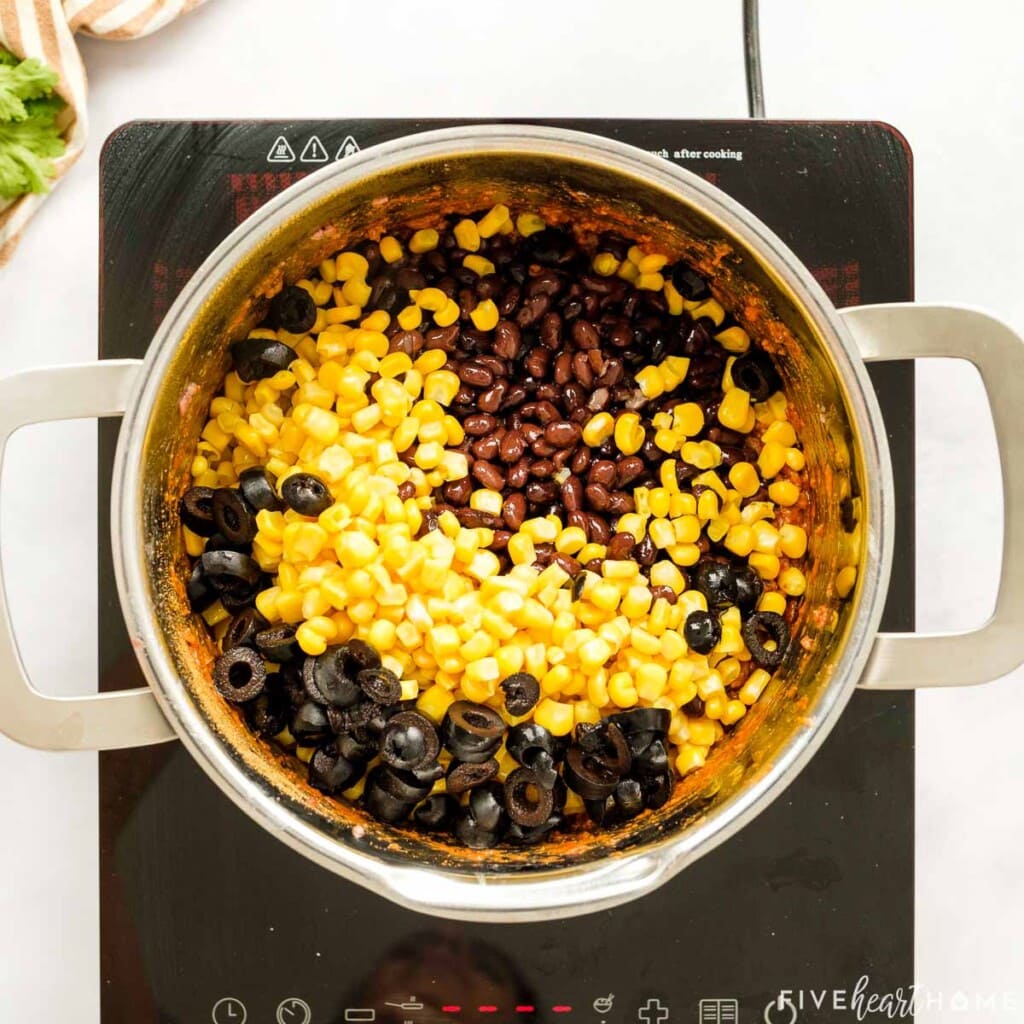 Adding black beans, corn, and black olives for Mexican Cornbread Casserole filling.