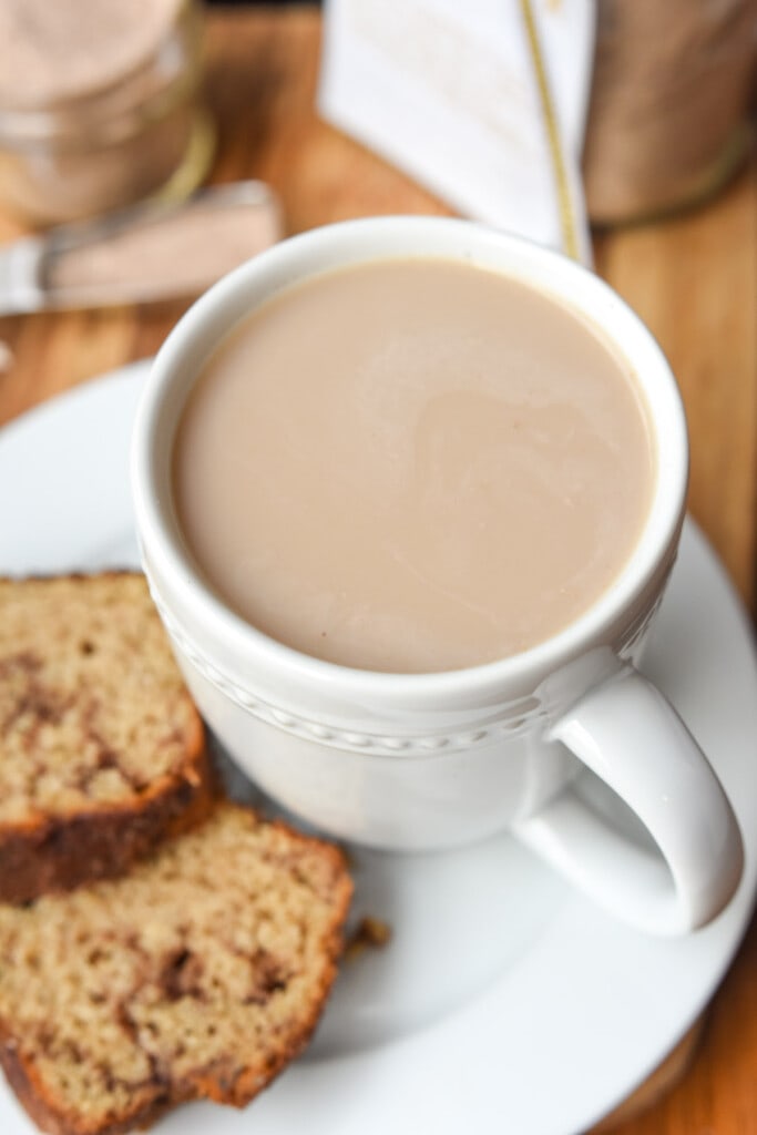 Chai tea latte in mug with cinnamon bread.