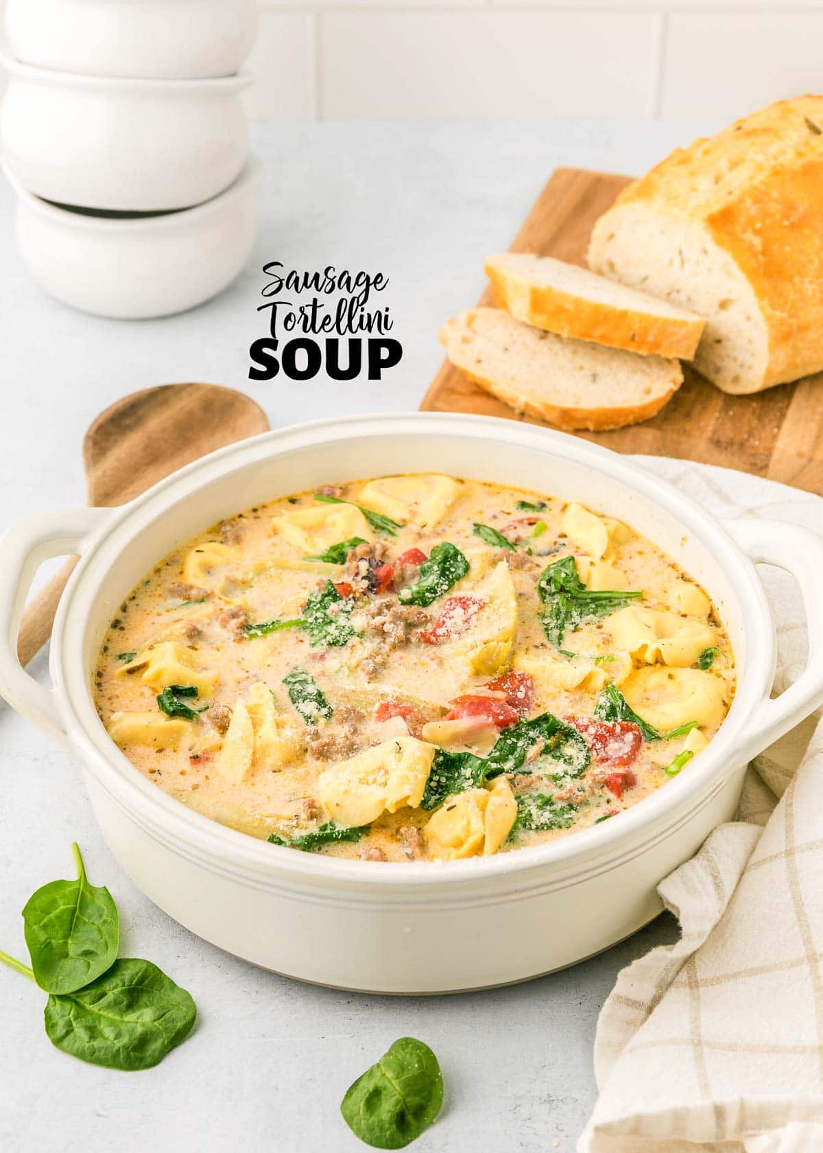 Sausage Tortellini Soup in white pot with text overlay.