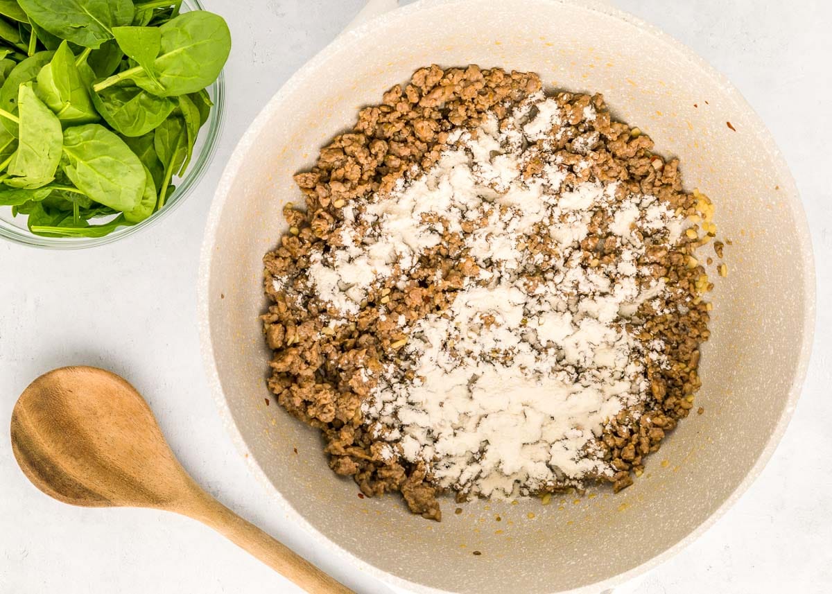 Cooked Italian sausage with flour sprinkled on top.