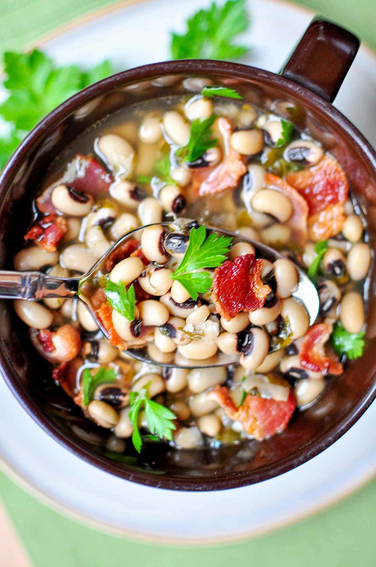 Spoonful of Black Eyed Peas New Years over bowl.