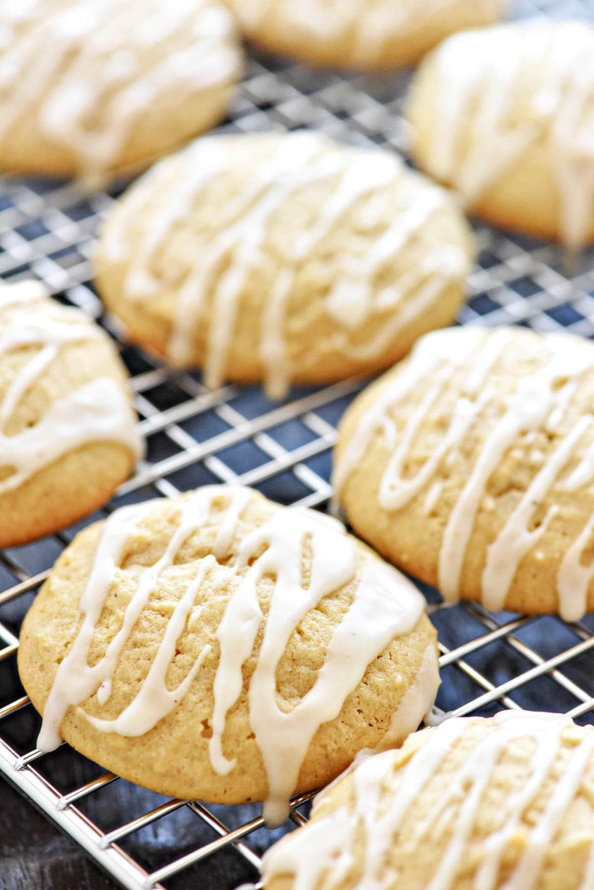 Eggnog Cookies recipe drizzled with eggnog glaze on cooling rack.