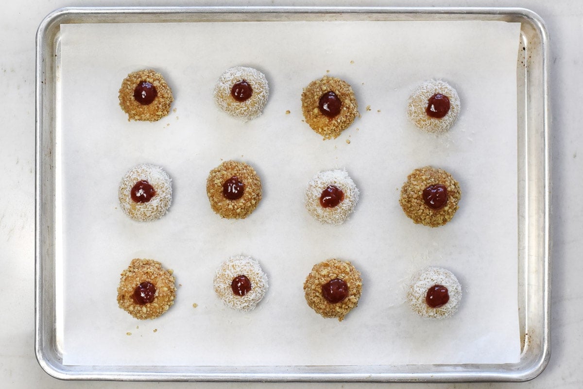 Jam Thumbprint Cookies on baking sheet, ready for oven.