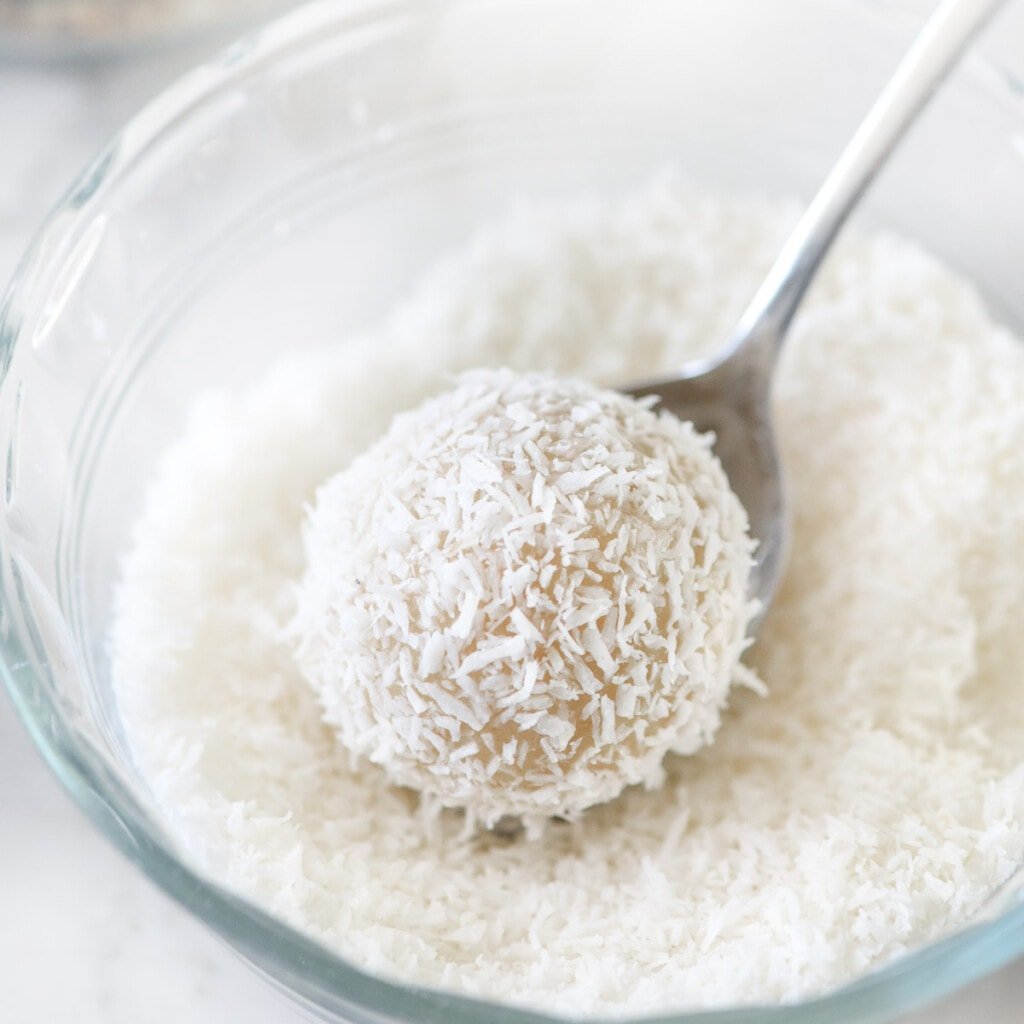 Coating thumbprint cookie recipe with coconut.