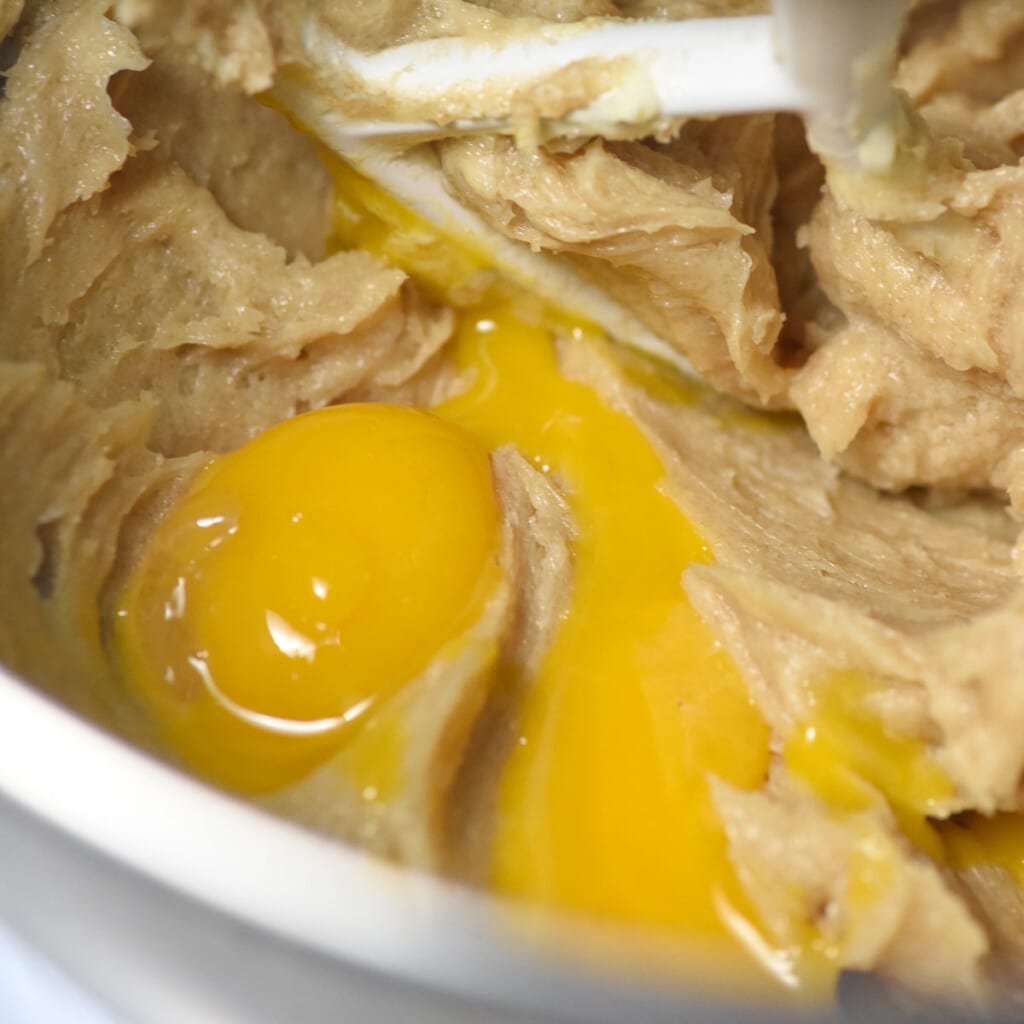 Adding eggs to thumbprint cookie recipe.