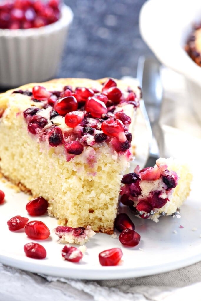 Pomegranate Cake slice with missing bite.