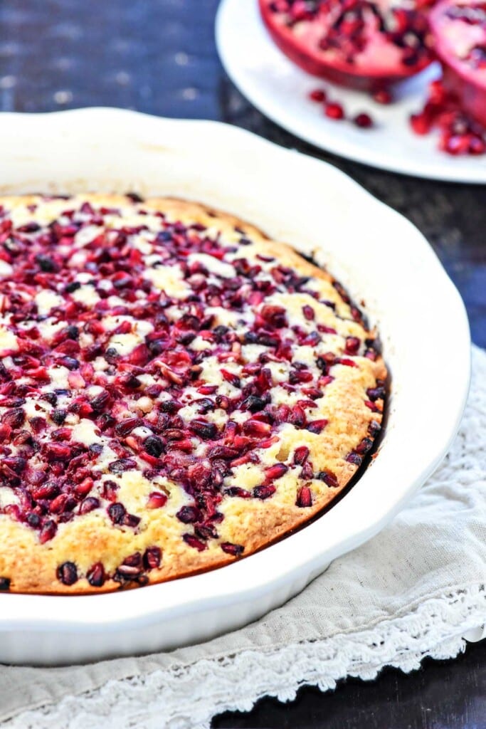 Pomegranate Cake in dish with pomegranate on plate.