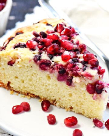 Pomegranate Cake with arils on plate.