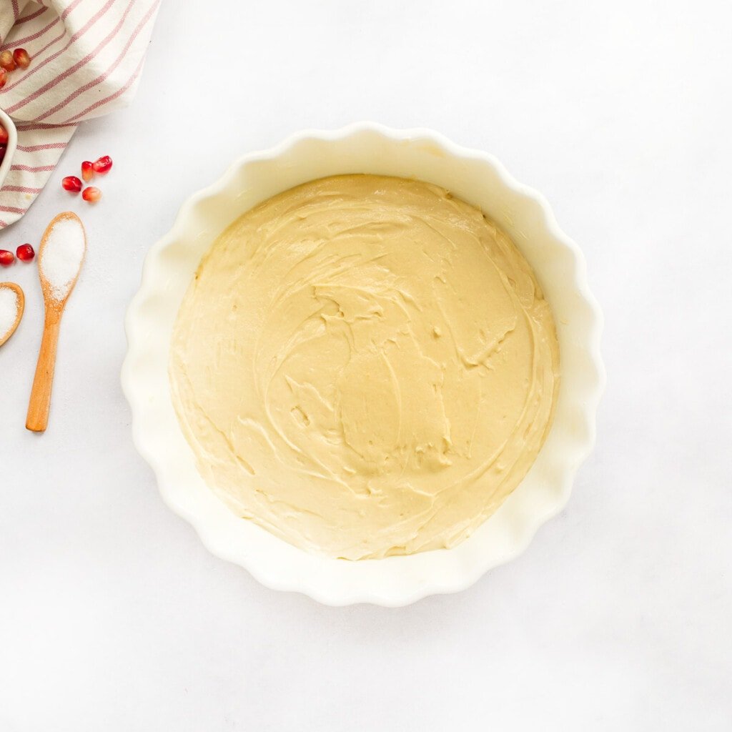 Spreading batter in dish for Pomegranate Cake.