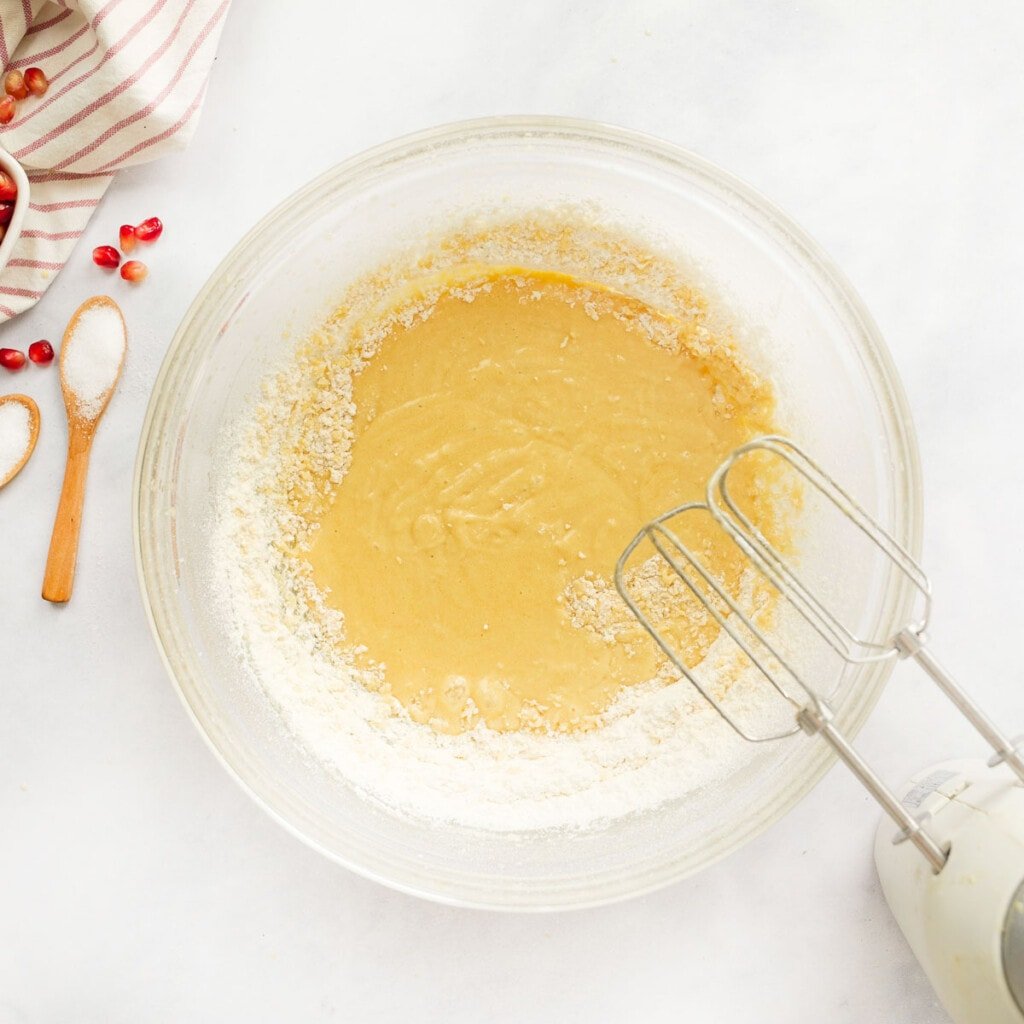 Mixing flour into wet ingredients.