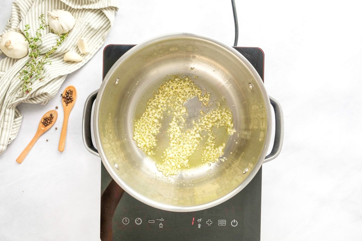 Sauteing garlic in pot for ham potato corn chowder.