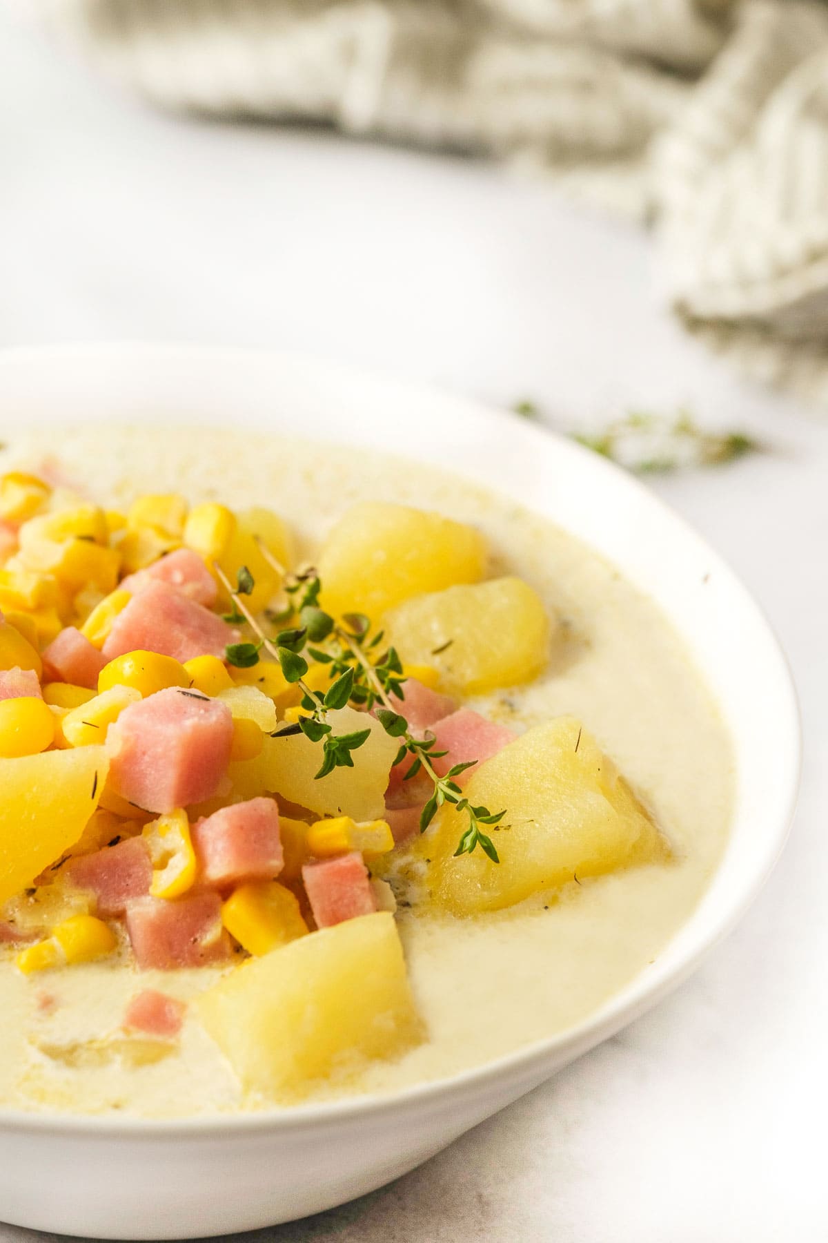 Potato Corn Chowder with fresh thyme garnish.