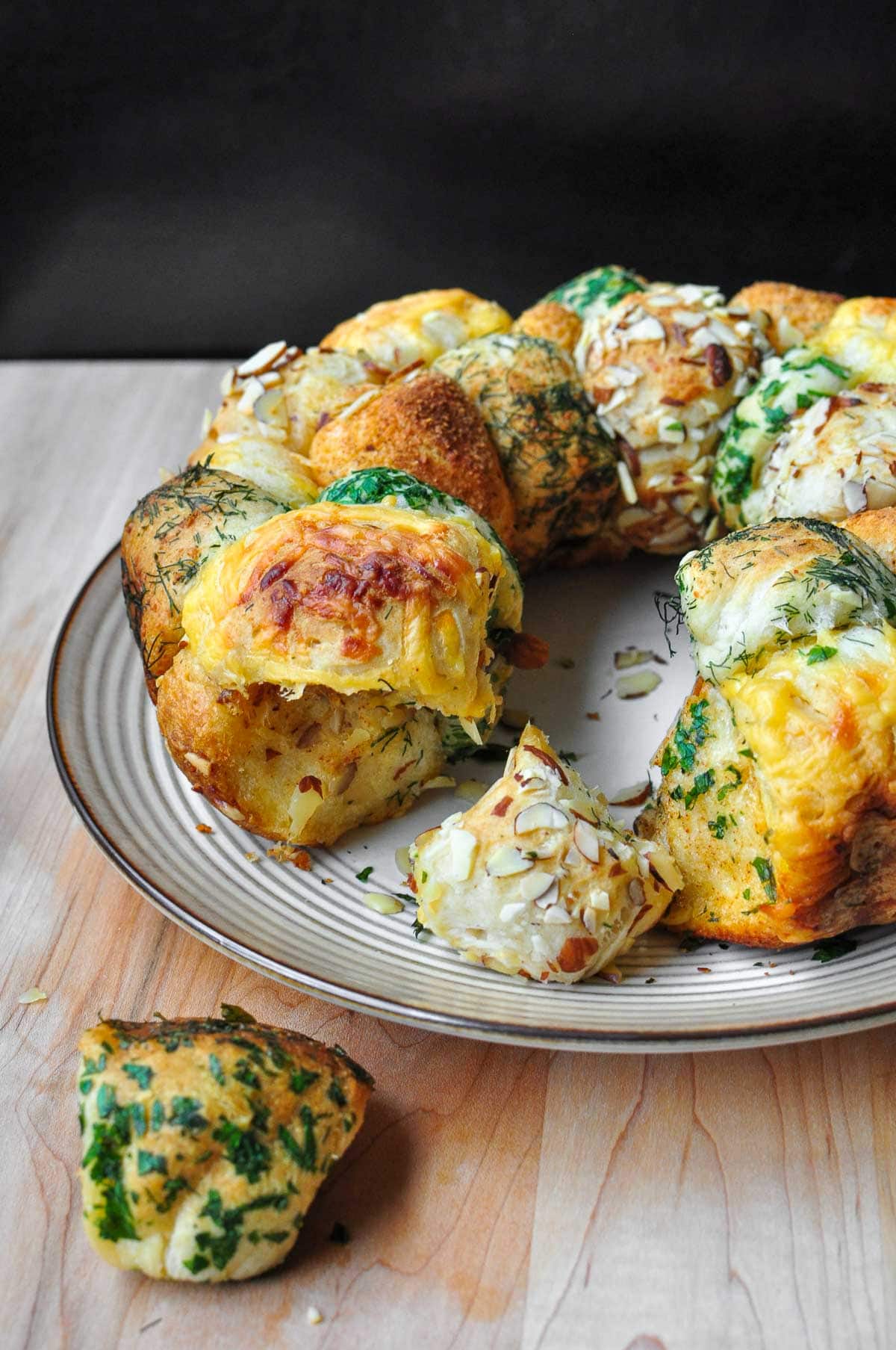 Monkey bread with herbs, nuts, and cheese pulled apart.